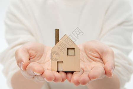 钢结构房屋双手捧房子房产保险背景