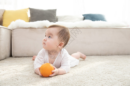 婴儿拿着橙子玩耍高清图片