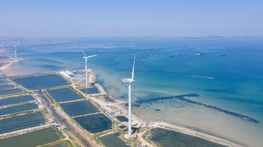 风光发电山东威海海边的风力发电机背景