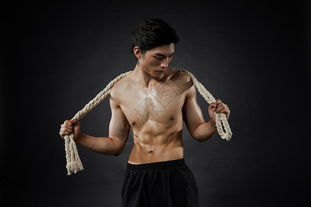 拿臂力绳的运动男性背景图片