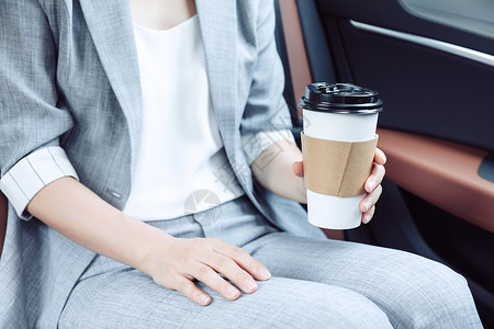 商务女性在汽车上喝咖啡图片