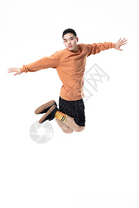 年轻街舞男生空中动作背景图片