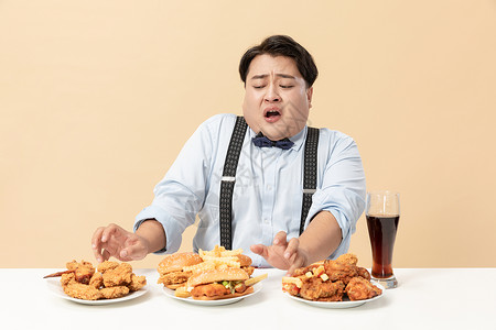 高热量食品汉堡旁男生拒绝高热量食物背景