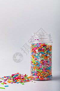 七彩六一儿童节塑料罐里的七彩糖背景