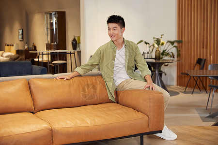 年轻男士家具店体验沙发真皮沙发高清图片素材