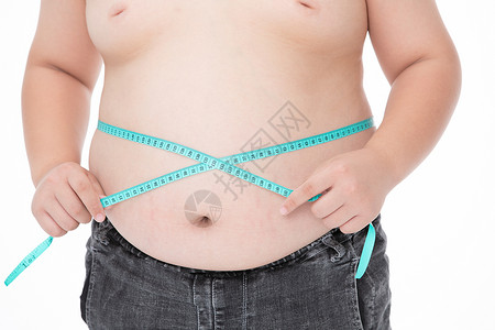 男孩用软尺测量腰围肥胖背景图片
