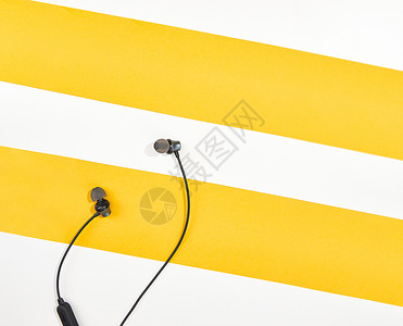 耳机放置在白黄拼接色桌面图片
