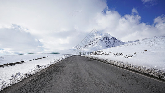 新疆雪山前行道路背景图片