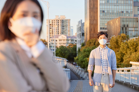 户外佩戴口罩防护的情侣背景图片