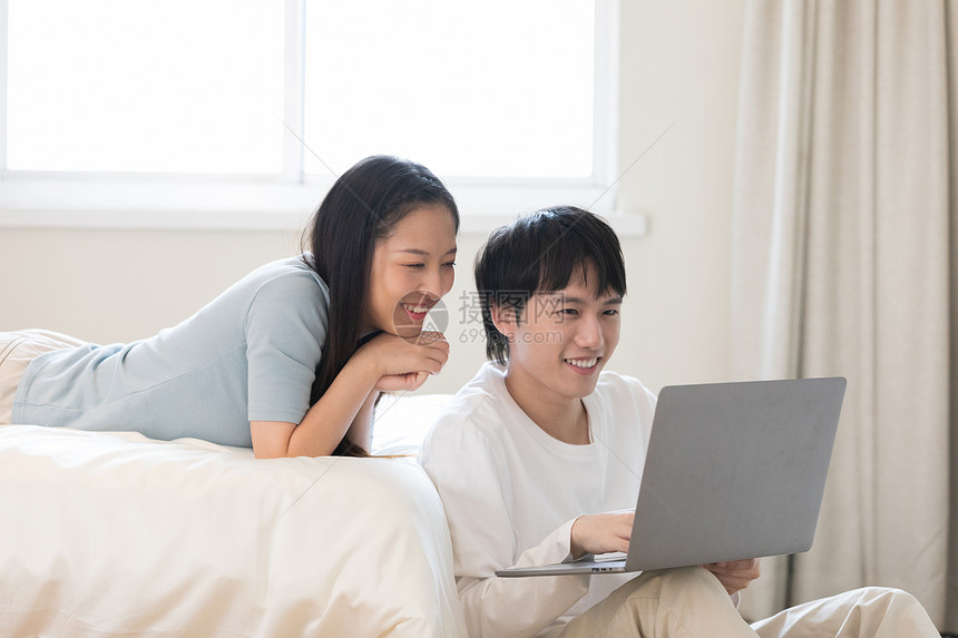 青年情侣居家生活玩电脑游戏图片