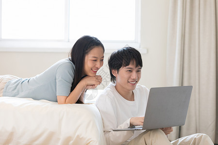 情侣玩电脑青年情侣居家生活玩电脑游戏背景
