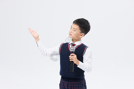 校服男孩小学生拿话筒主持演讲背景