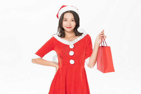 圣诞美女购物拎购物袋礼物背景图片