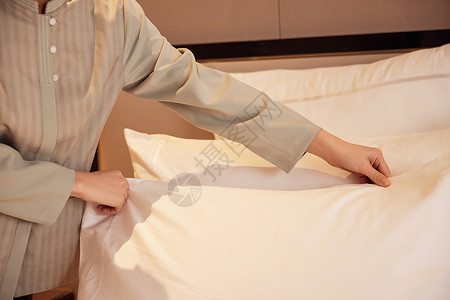 酒店服务员整理客房床铺东方人高清图片素材