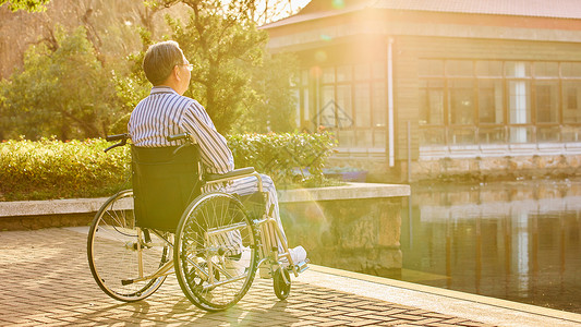 健康在于行动坐在轮椅上孤独的老人背影背景