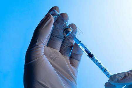 注射器抽取疫苗手部特写背景图片
