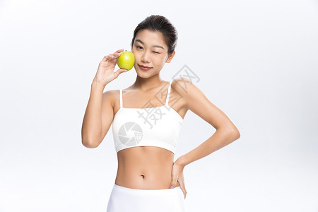 塑形塑身美女手拿苹果饮食管理背景图片