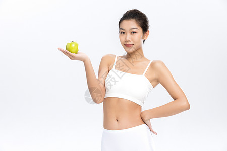 塑形塑身美女手拿苹果饮食管理背景