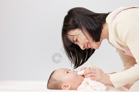月嫂与婴儿宝宝温馨互动照顾高清图片素材