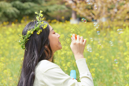 花环少女春季油菜花田可爱少女背景