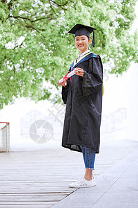 硕士研究生手举毕业证书庆祝毕业硕士服高清图片素材