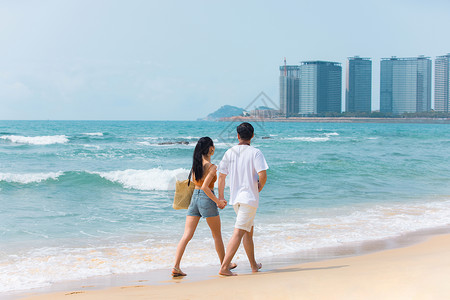 夏日戏水夏日情侣海边沙滩散步背景