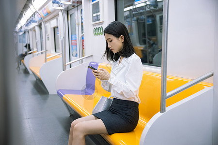 地铁上看手机的女性出行工具高清图片素材