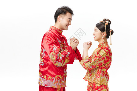 穿中式古装结婚礼服的新娘和新郎问候手势背景图片