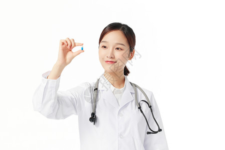 女性青年医生护士手拿药品胶囊图片