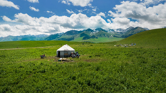 航拍5A景区新疆那拉提绿色草原与毡房背景图片