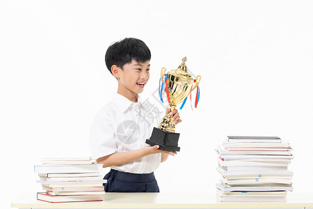 竞赛知识举着奖杯开心的小男孩背景