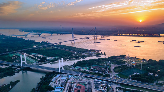 南京大桥南京鱼嘴湿地公园与长江边的夕阳晚霞背景