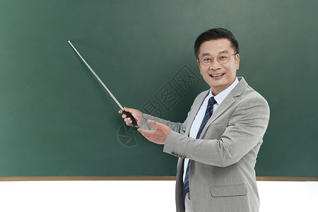 中年教授手持教棒在黑板前演讲图片