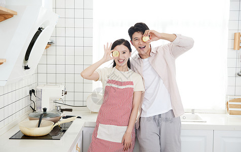 美女用餐快乐的年轻情侣在厨房里玩耍背景