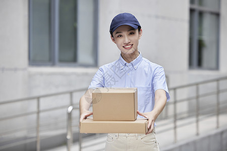 女性快递员微笑送快递高清图片