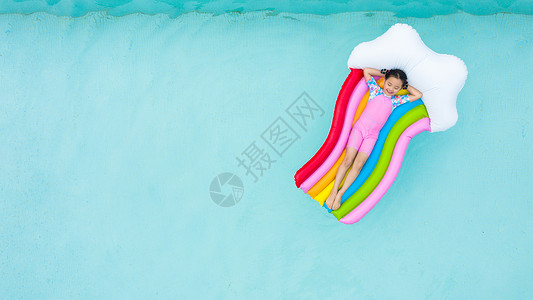在彩虹桥下儿童小女孩躺在泳池彩虹气垫床上背景