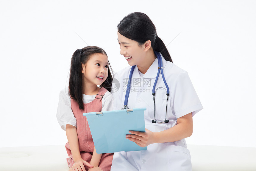 女医生和小女孩坐在病床上看病例图片