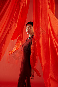红色飘带背景中的旗袍美女形象背景
