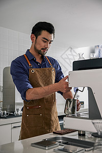 奶杯男性咖啡师操作机器打奶泡背景