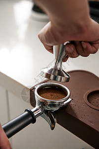 咖啡师按压咖啡粉特写图片