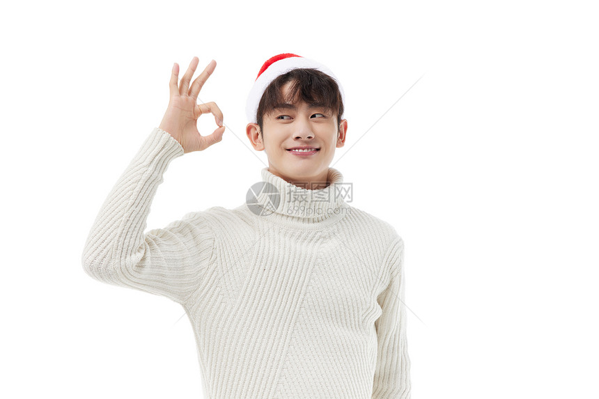 青年男性过圣诞节戴圣诞帽ok手势图片