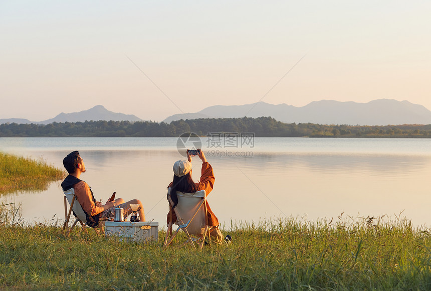 年轻情侣湖边享受大自然图片