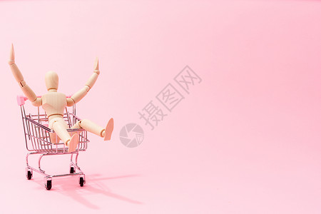 粉色背景下小人欢快购物概念高清图片