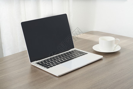 咖啡工具商务桌面上的咖啡杯和电脑背景