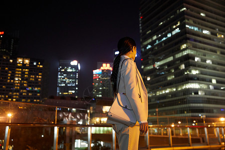 都市商务女性夜晚行走背影高清图片