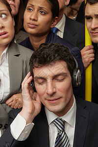 商务男性在地铁上戴耳机图片