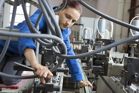 女性工人作机械操作车间高清图片素材
