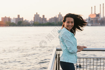 黄昏时市滨水边中成年女肖像河高清图片素材