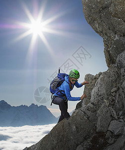 法国勃朗峰日落时在岩石墙上攀的女登山者图片