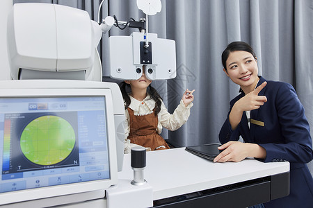 小女孩正在验光机器上检查视力图片